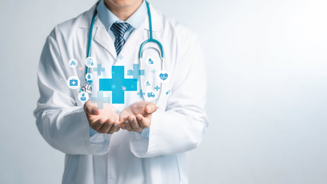 Provider with hands open holding a computer graphic of medical symbols