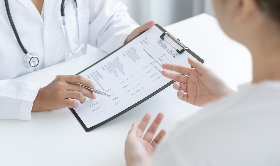Provider reviewing chart with patient